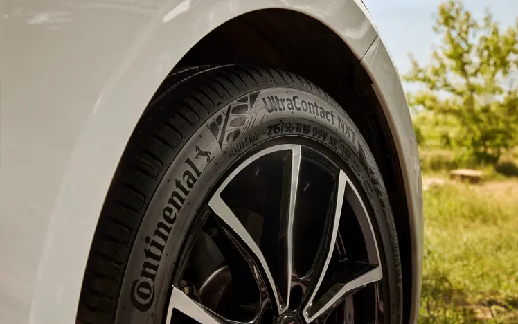 Close-up of a Continental UltraContact NXT tyre, highlighting tread pattern and eco-friendly performance features.