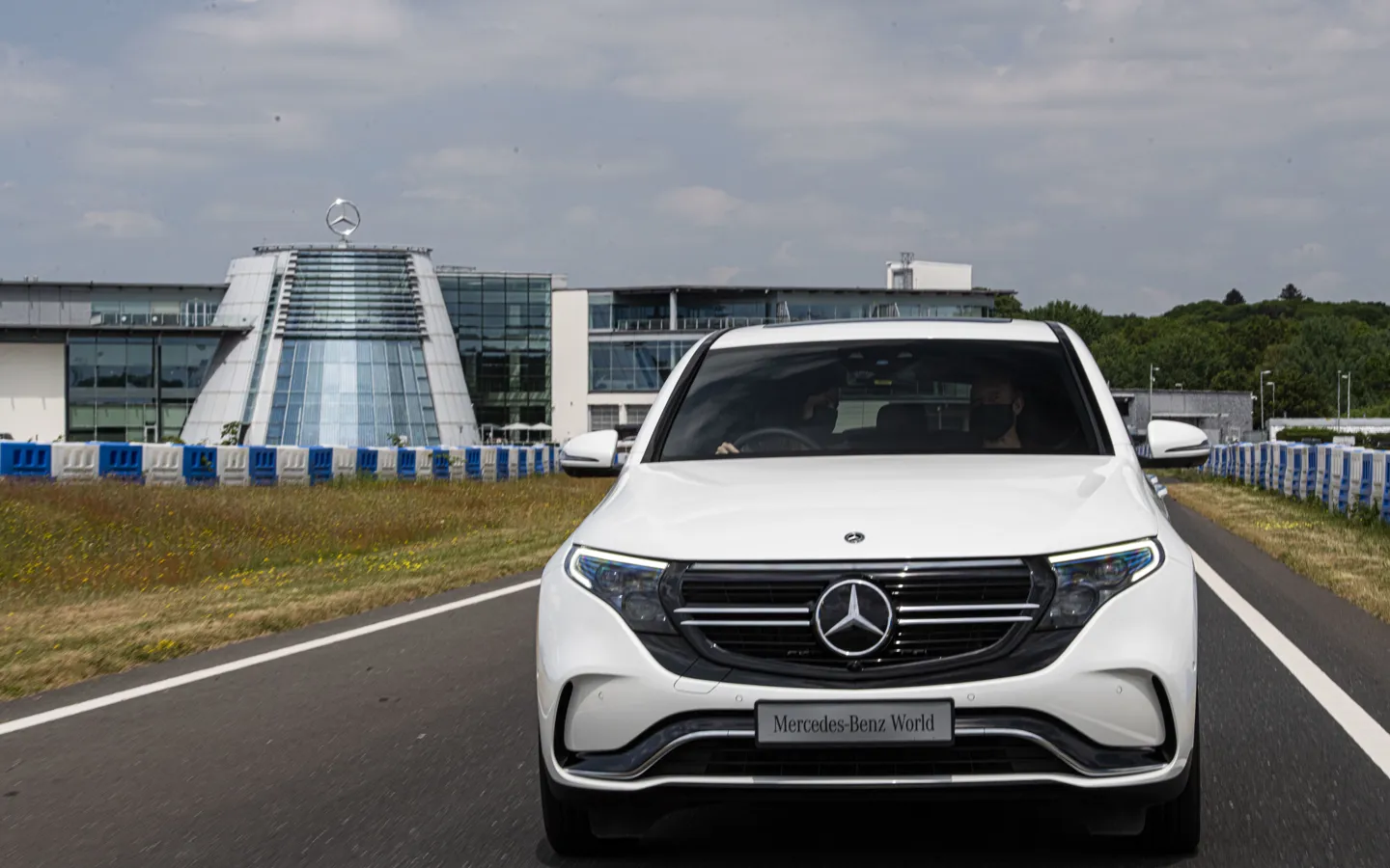 Corporate event setup at Mercedes-Benz World with professional lighting, seating arrangements, and presentation screens in a modern venue space.