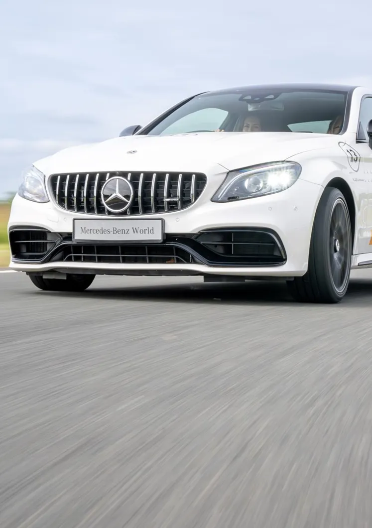 Mercedes-AMG 63 in action on a dynamic driving track at Mercedes-Benz World during a high-performance one-hour experience.