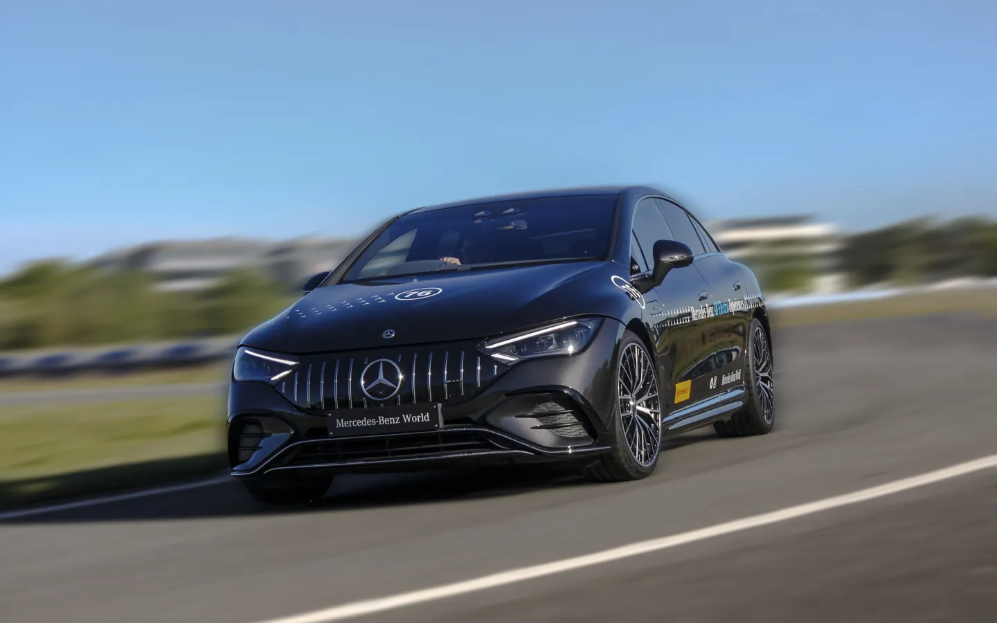 Mercedes-Benz EQE 53 on track at Mercedes-Benz World, celebrating the brand’s rich automotive heritage and design evolution.
