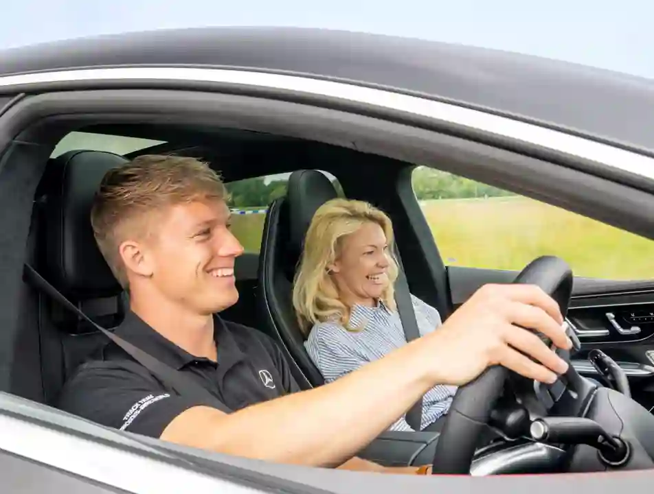 Pro Driver and passenger inside a Mercedes-AMG 63 during a high-speed ride at Mercedes-Benz World, capturing excitement and elite performance.