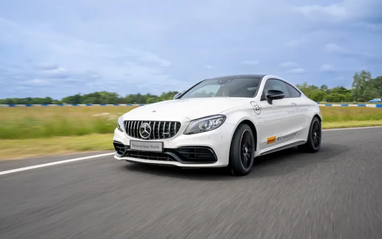 Mercedes-Benz performance cars on display for driver experiences at Mercedes-Benz World, ready for an exhilarating track session.